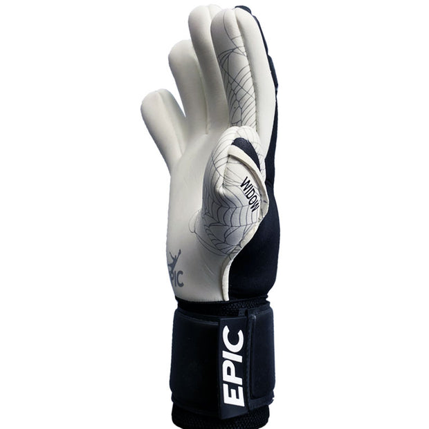 White and black soccer goalkeeper glove with the word "WIDOW" printed on the thumb and the word "EPIC" printed on the strap. This is a negative cut soccer goalie glove. A spider web design is printed on the palm of the glove. 
