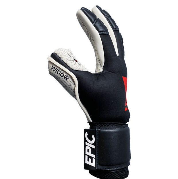 Red, white and black soccer goalkeeper glove with the word "WIDOW" printed on the thumb and the word "EPIC" printed on the strap. This soccer goalie glove is 4mm of German contact latex on the palm. A spider web design is printed on the palm of the glove. 